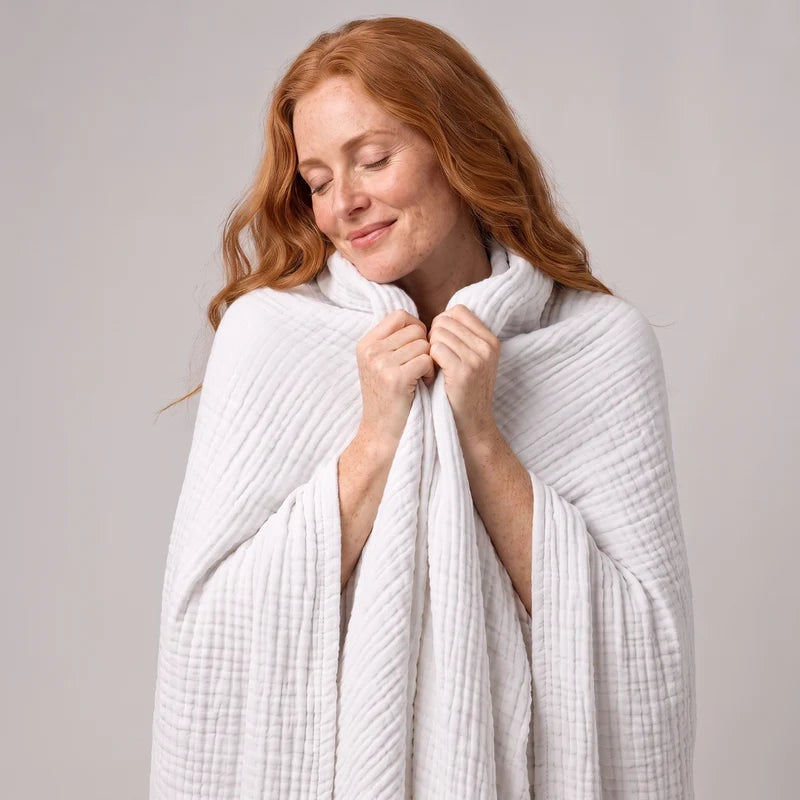 Woman wrapped head to toe in the Muslin Blanket in White